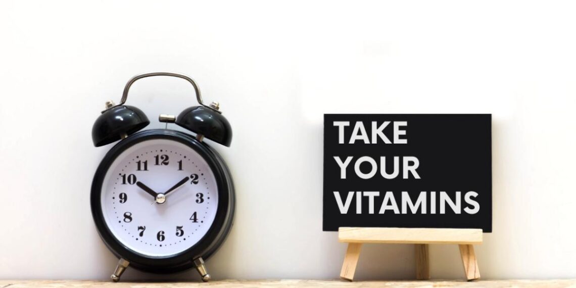 clock with a sign saying take your vitamins