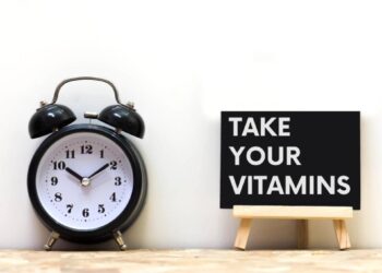 clock with a sign saying take your vitamins