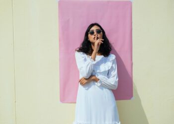 woman standing in front of building doing a shush