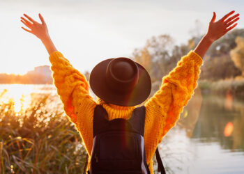 woman outside with hands in the air