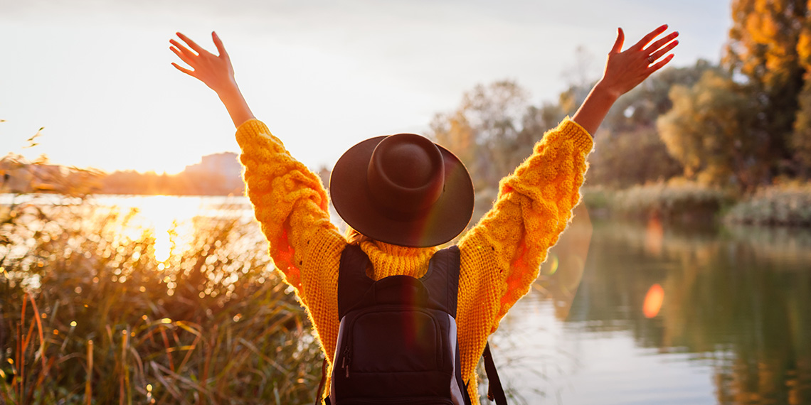 woman outside with hands in the air