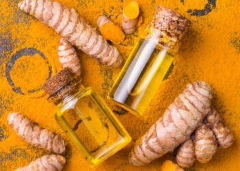 curcumin and turmeric dusted on a dark surface.