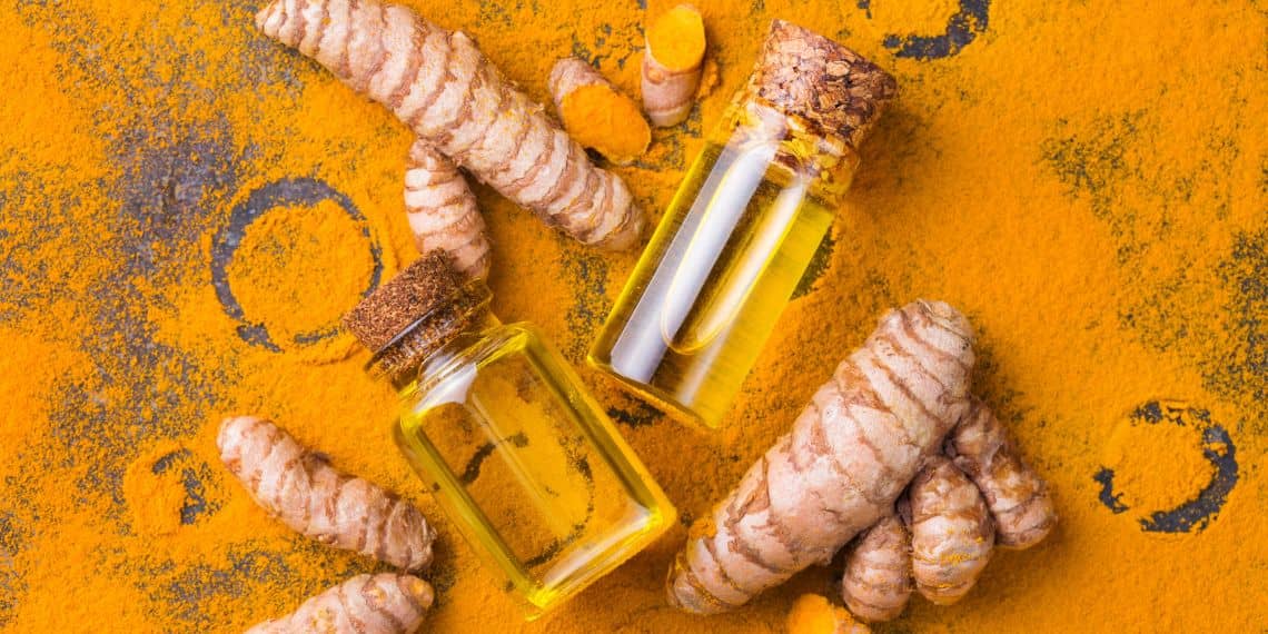 curcumin and turmeric dusted on a dark surface.