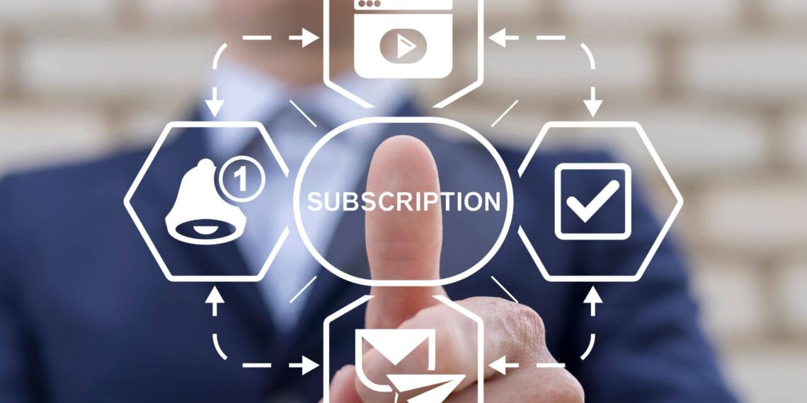 A person in a suit points at a digital interface displaying the word "subscription" surrounded by icons for videos, notifications, and emails.