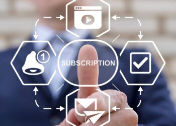 A person in a suit points at a digital interface displaying the word "subscription" surrounded by icons for videos, notifications, and emails.