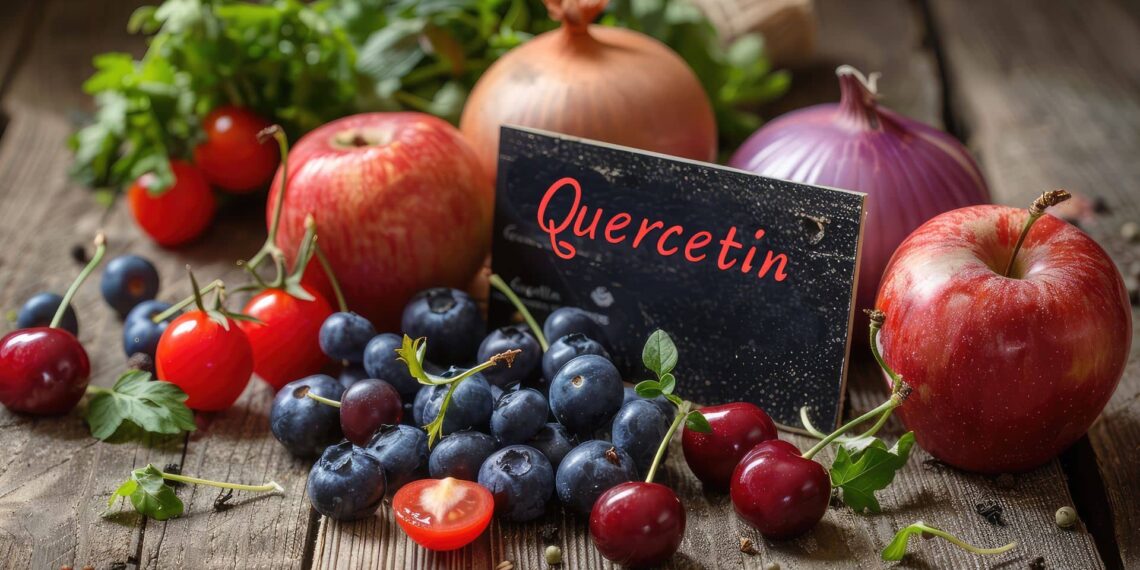 A group of apples, blueberries, cherries, tomatoes, onions, and herbs surround a card labeled "Quercetin" on a wooden surface.